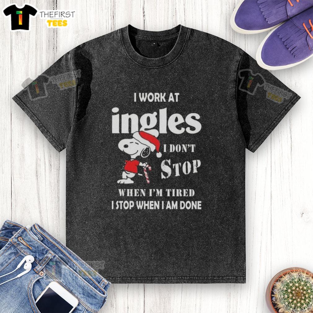 Alt Text: Snoopy graphic t-shirt for Christmas featuring 'I work at Ingles Markets, I don't stop when I'm tired' slogan.