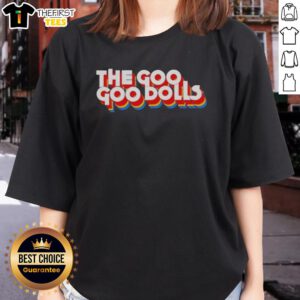 Alt Text: Neil Barrow wearing the stylish Top The Diplomat Goo Ladies Tee in a vibrant setting, showcasing trendy fashion.