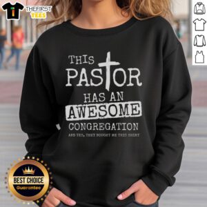 Alt Text: Pastor wearing 'Top This' sweatshirt with a vibrant congregation in a lively church setting.