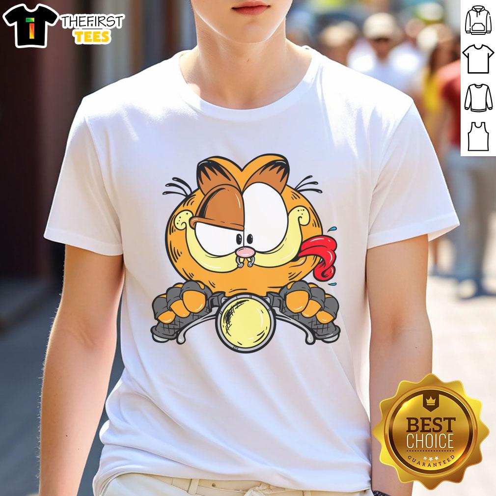 Alt Text: Premium cartoon Garfield cat riding a motorcycle on a stylish T-shirt, perfect for cat lovers and fans of humor.