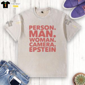 Premium man and woman wearing Epstein washed t-shirts, posing with a camera in a stylish outdoor setting.