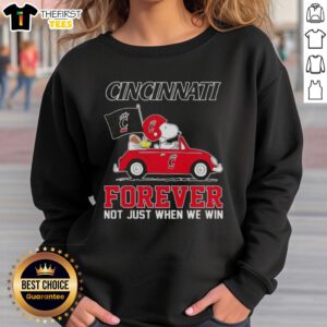 Alt Text: Snoopy driving a car on a Cincinnati Bearcats sweatshirt, promoting Forever, Not Just When We Win theme.