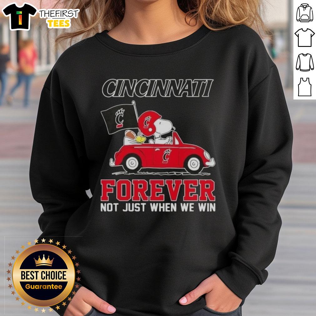 Alt Text: Snoopy driving a car on a Cincinnati Bearcats sweatshirt, promoting Forever, Not Just When We Win theme.