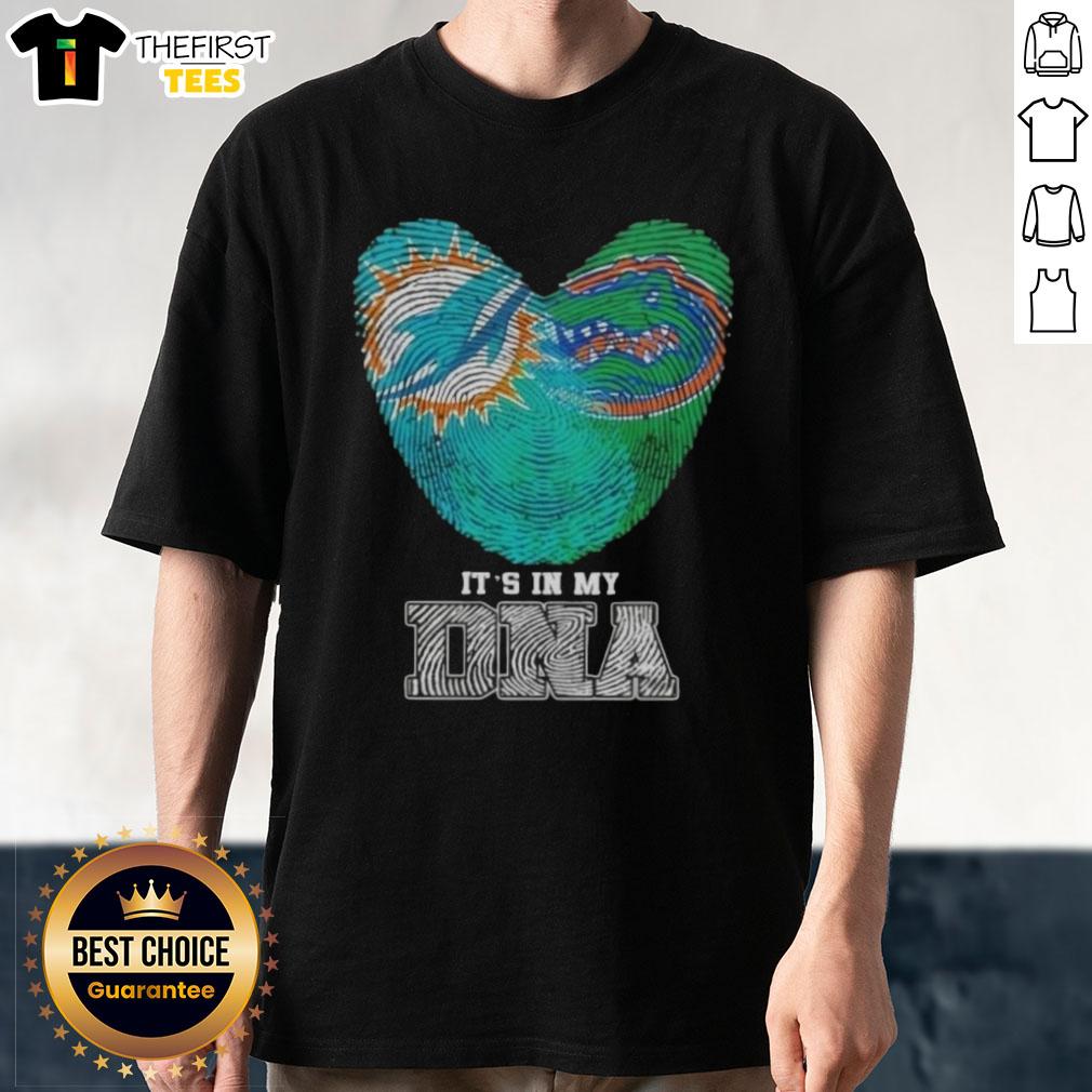 Alt Text: Top Fingerprints Miami Dolphins X Florida Gators It's In My DNA T-Shirt featuring team logos and vibrant graphics.