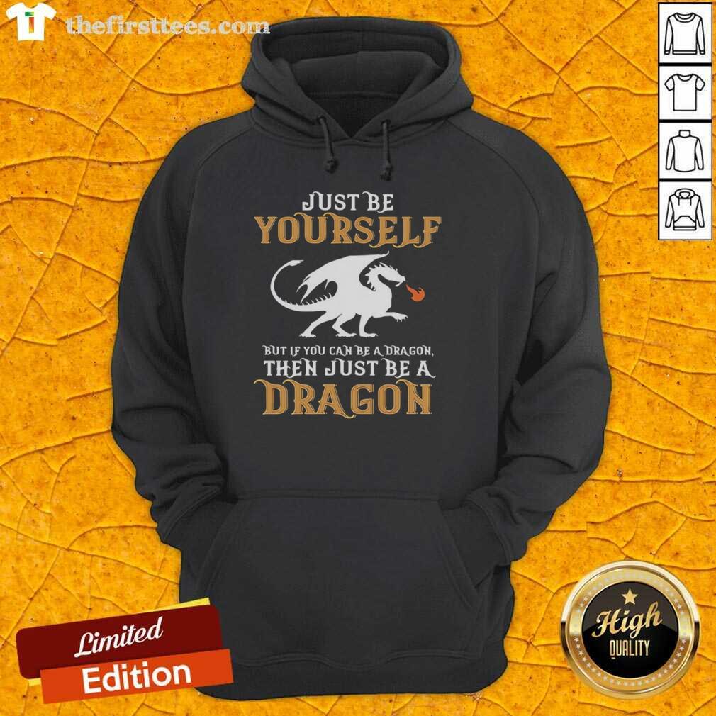 Alt Text: Stylish hoodie featuring the phrase 'Just Be Yourself, But If You Can Be A Dragon, Be A Dragon' for unique fashion.