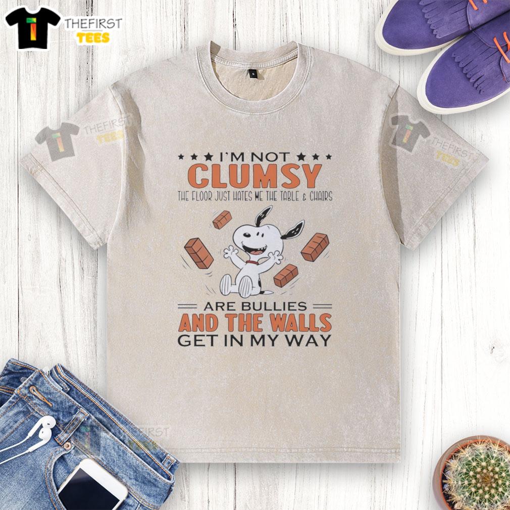 Alt Text: Cute Snoopy 'I'm Not Clumsy, The Floor Just Hates Me' T-Shirt featuring whimsical design with table and chairs