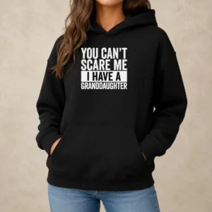 Funny You Can'T Scare Me I Have A Granddaughter Hoodie in black, cozy pullover with front pocket and drawstring hood