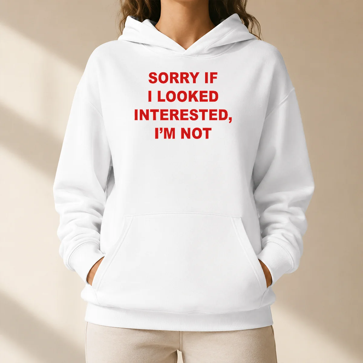 Good Sorry If I Looked Interested I'M Not Bold Capitalized Statement Quote Hoodie in black, front view with bold white text