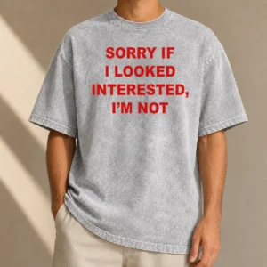 Good Sorry If I Looked Interested I'M Not Bold Capitalized Statement Quote printed on a soft washed t shirt in neutral color