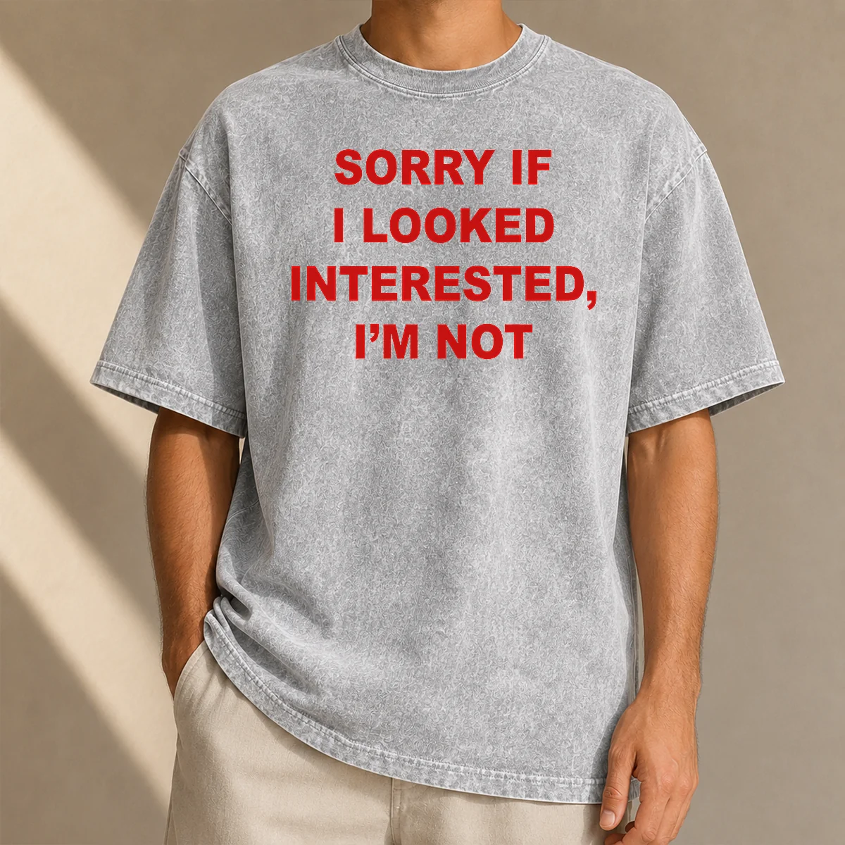 Good Sorry If I Looked Interested I'M Not Bold Capitalized Statement Quote printed on a soft washed t shirt in neutral color